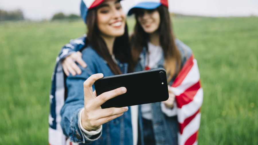 female-friends-colored-caps-taking-selfie